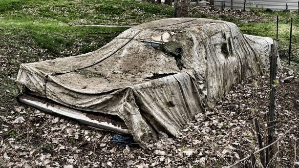 istock Dirty old car with cover 1315652465