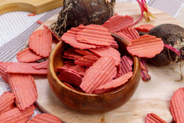 healthy homemade vegetable chips in beetroot. Organic diet food. Vegetarian plant based snack concept.