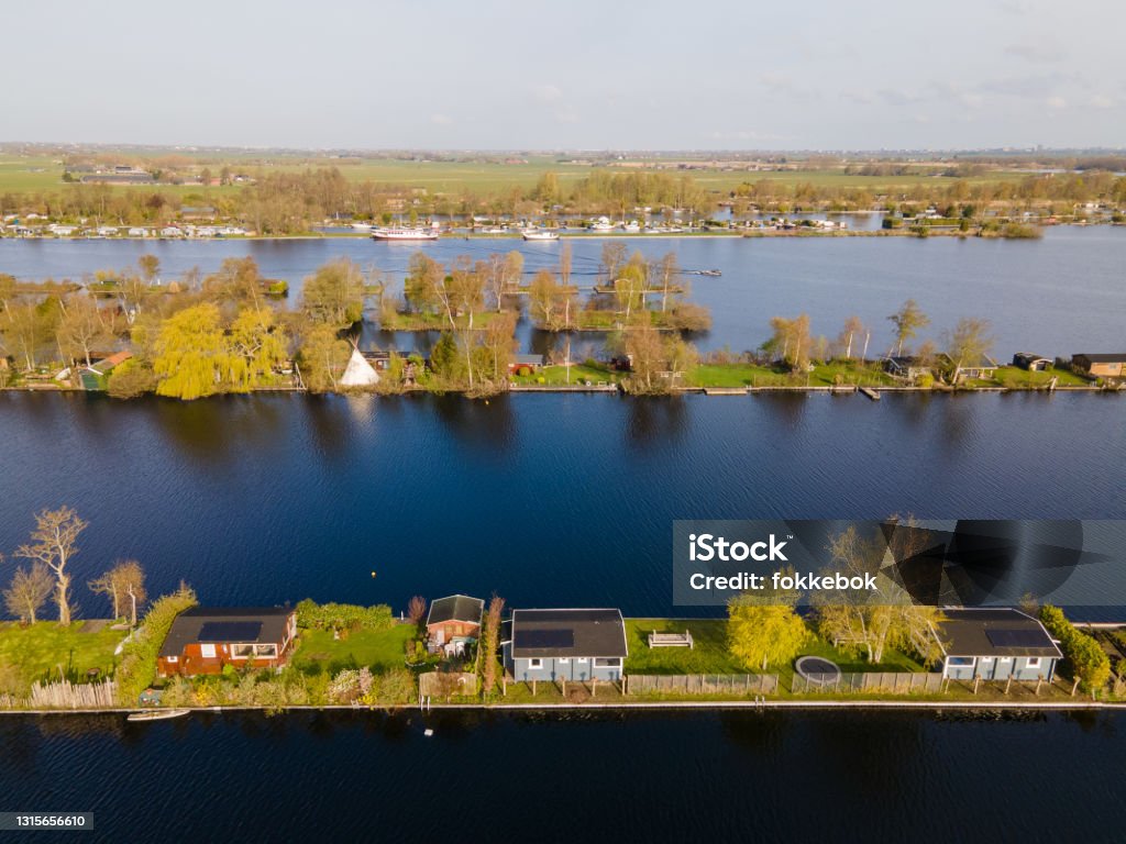 Aerial view of small islands in the Lake Vinkeveense Plassen, near Vinkeveen, Holland. It is a beautiful nature area for recreation in the Netherlands Aerial view of small islands in the Lake Vinkeveense Plassen, near Vinkeveen, Holland. It is a beautiful nature area for recreation in the Netherlands. Vinkeveen is mainly famous for the Vinkeveense Plassen Aerial View Stock Photo