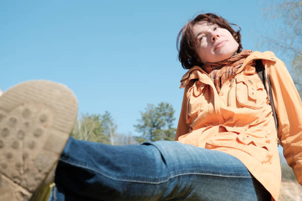 istock Mature woman is resting in sunny forest 1315663839
