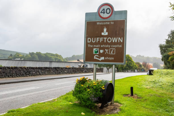 "Welcome to Dufftown. The malt whisky capital" road sign in Dufftown, Scotland "Welcome to Dufftown. The malt whisky capital" road sign in Dufftown, Scotland. moray firth stock pictures, royalty-free photos & images