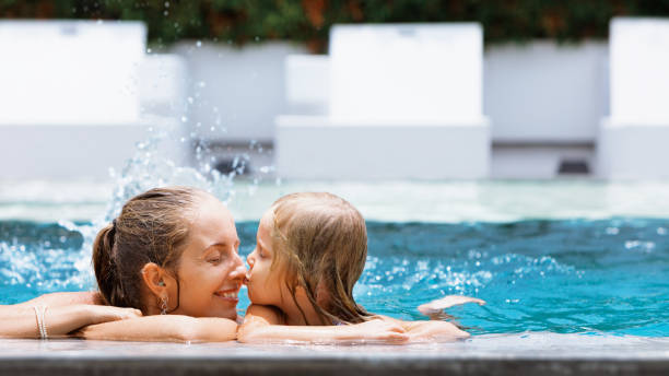 Happy people have fun at pool side edge.