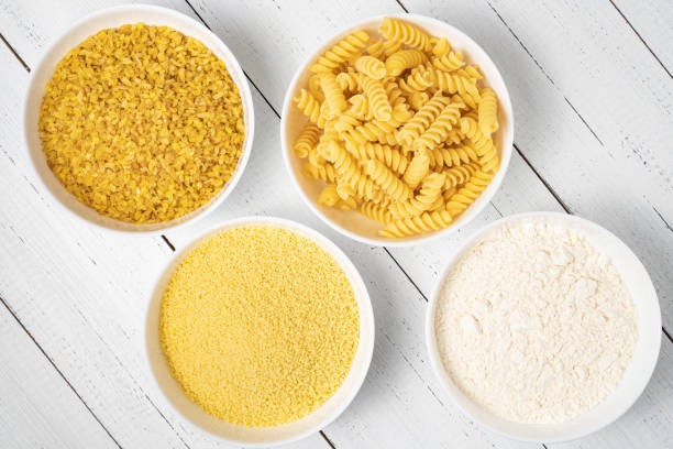 istock Flour, koukous, bulgur and pasta in bowl on wood table, top view. Various wheat products concept. 1315676352