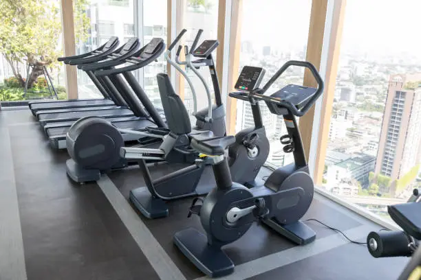 Photo of Sports equipment in the gym. Modern gym interior with equipment. Cardio machine in gym with modern fitness equipment for fitness events and more. fitness cardio training Healthy lifestyle concept.