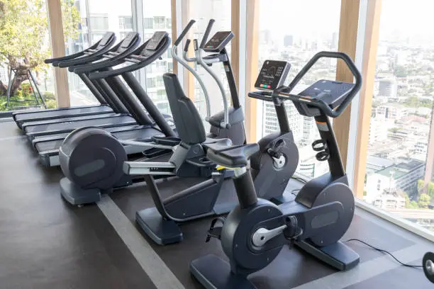 Photo of Sports equipment in the gym. Modern gym interior with equipment. Cardio machine in gym with modern fitness equipment for fitness events and more. fitness cardio training Healthy lifestyle concept.