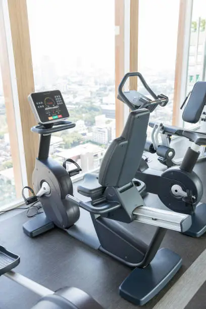 Photo of Sports equipment in the gym. Modern gym interior with equipment. Cardio machine in gym with modern fitness equipment for fitness events and more. fitness cardio training Healthy lifestyle concept.