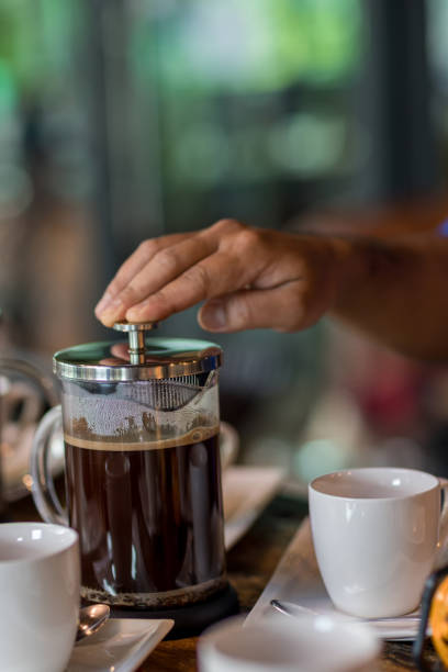 istock Hand preparing coffee in French Press Coffee Maker. Morning concept. coffee siphon. Spent coffee break at the organic cafe and prepare Chocolate or tea in French press. 1315681728