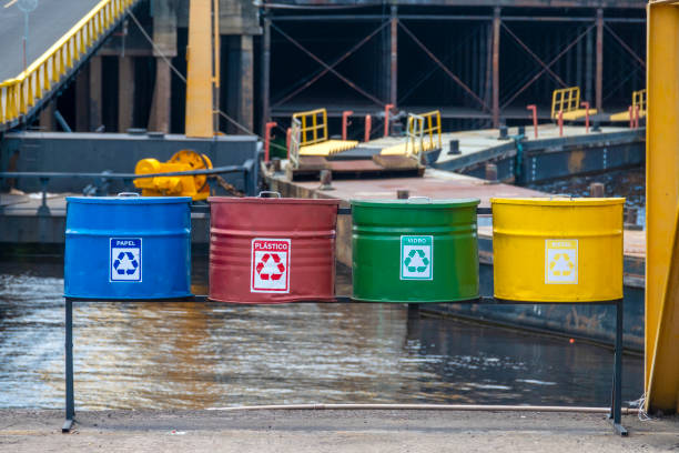 From left to right: trash cans for paper, plastic, glass and metal