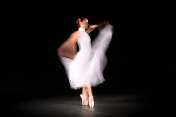 istock Ballerina is dancing black background 1315683389