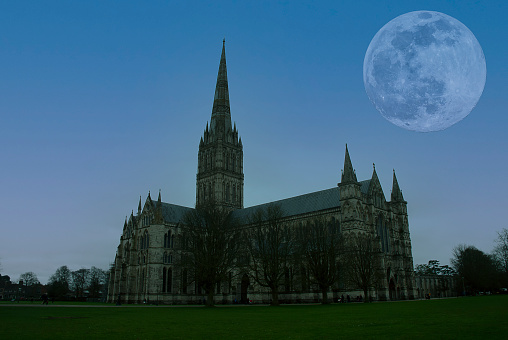 The silhouette of Salisbury Cathedral under the light of full moon in Wiltshire, UK