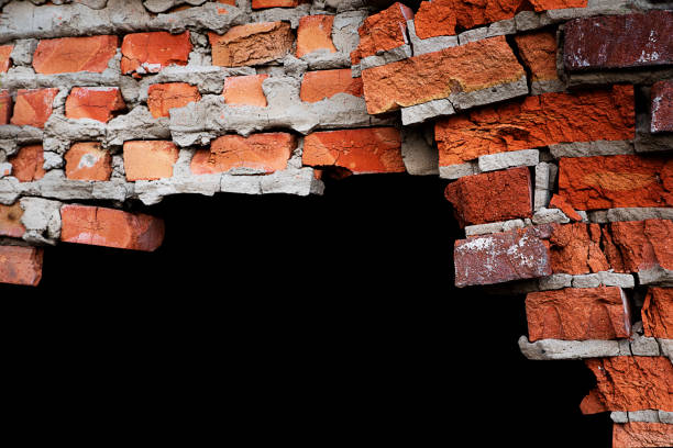 istock Old textured red brick wall isolated on black background. 1315688380