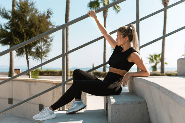 young  and sexy woman athlete during summer street workout - determination running staircase jogging imagens e fotografias de stock