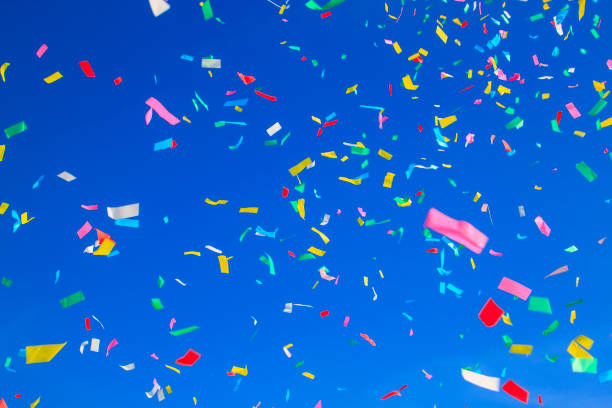 istock multicolored confetti on clear blue sky background 1315694322