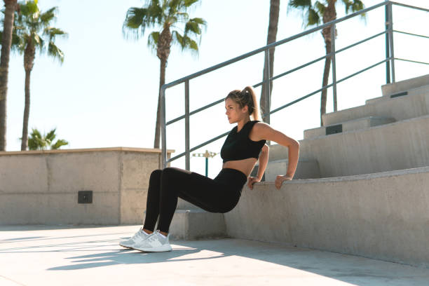 istock Athletic woman is doing triceps dip during summer calisthenic workout 1315696015