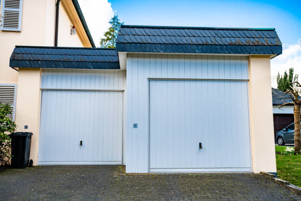 istock wide garage door and concrete driveway in front 1315696466
