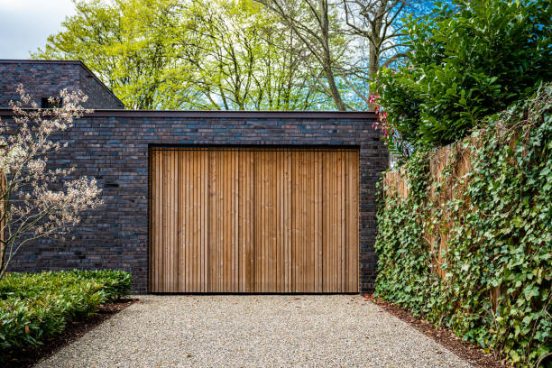 istock wide garage door and concrete driveway in front 1315697461
