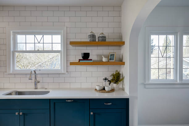 View of a kitchen with a sink, storage and a tile backsplash stock photo