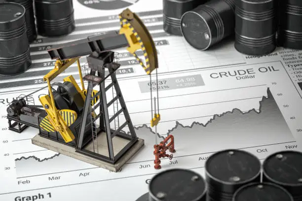 Photo of Oil pump jack and barrels on newpaper with growth of price of crude oil. Stock market of crude oil, investment and petroleum industry.