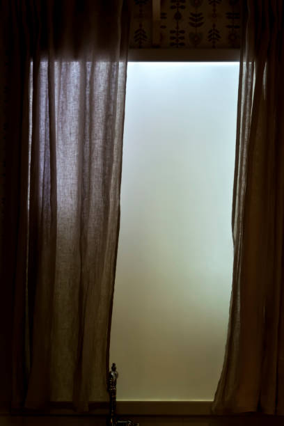 istock Frosted opaque window with curtains in kitchen. Retro hipster faded style of processing. Grey and gloomy mood 1315704482