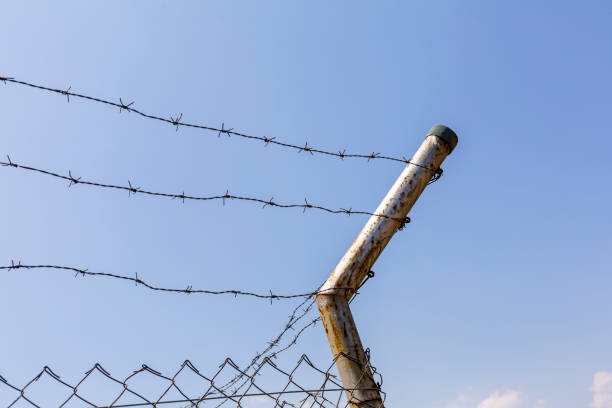 istock A building fence surrounded by barbed wires 1315707453
