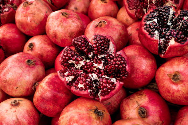 istock Cracked pomegranate. Ripe Pomegranates Background 1315709612