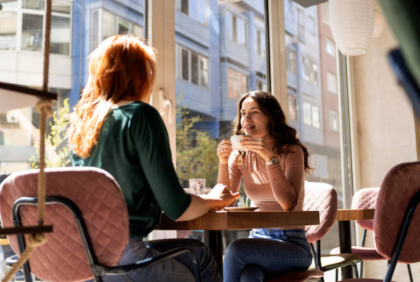 istock Friends sitting in a coffee shop drinking coffee talking 1315709937