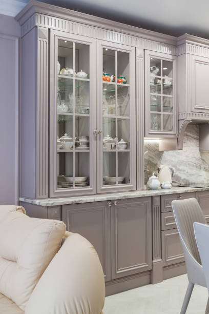 istock Modern beige and grey colored kitchen interior in classic style with dining table in luxury home 1315712950