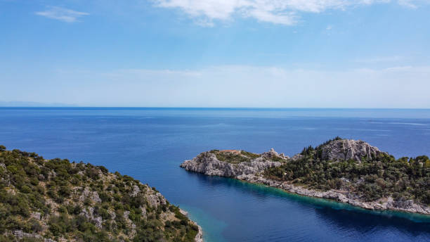 istock Green hills clear sky with turquoise sea 1315716177