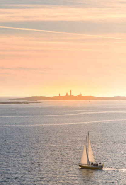 Sailing in Kattegat sea at sunset. Famous Lighthouse of Vinga Fyr outside Gothenburg, Sweden.