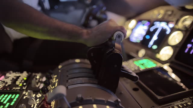 Side view of airline pilot's hand pushing throttle