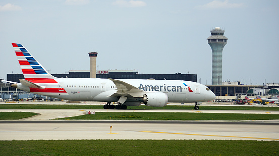 Bensenville, IL, USA - April 23 2021: American Airlines Boeing 787 Dreamliner taxies to the terminal after landing at Chicago O'Hare International Airport.