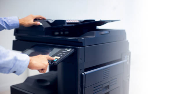 istock Bussiness man Hand press button on panel of printer, printer scanner laser in office copy machine supplies start concept. 1315755248
