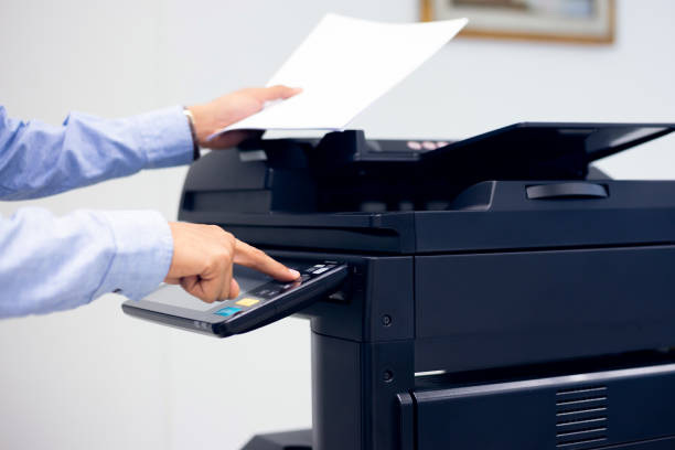 istock Bussiness man Hand press button on panel of printer, printer scanner laser in office copy machine supplies start concept. 1315755258