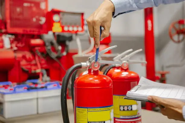 Engineer inspection Fire extinguisher and fire hose,Ready to use in the event of a fire.Safety first concept.