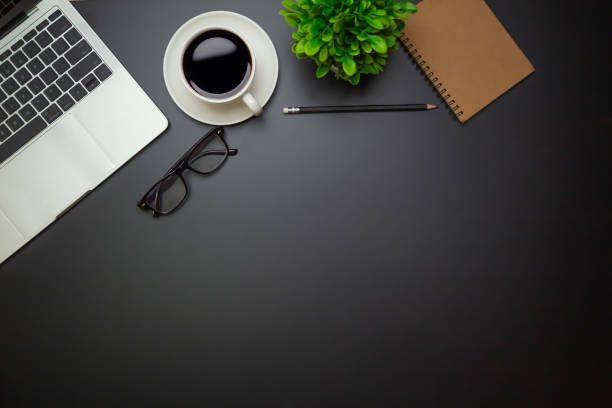 istock Workspace - Flat top view illustration of a workspace with a coffee cup and notebook on the black desk surface,Office desk concept. 1315756053
