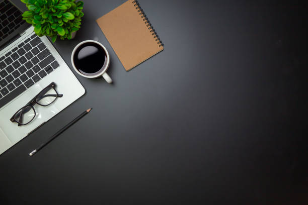 istock Workspace - Flat top view illustration of a workspace with a coffee cup and notebook on the black desk surface,Office desk concept. 1315756091