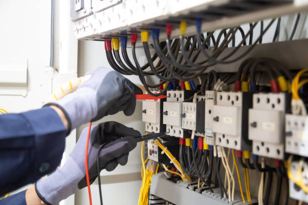 istock Electrician engineer tests electrical installations and wires on relay protection system. Adjustment of scheme of automation and control of electrical equipment. 1315756123