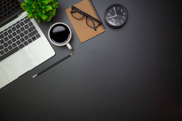 istock Workspace - Flat top view illustration of a workspace with a coffee cup and notebook on the black desk surface,Office desk concept. 1315756127