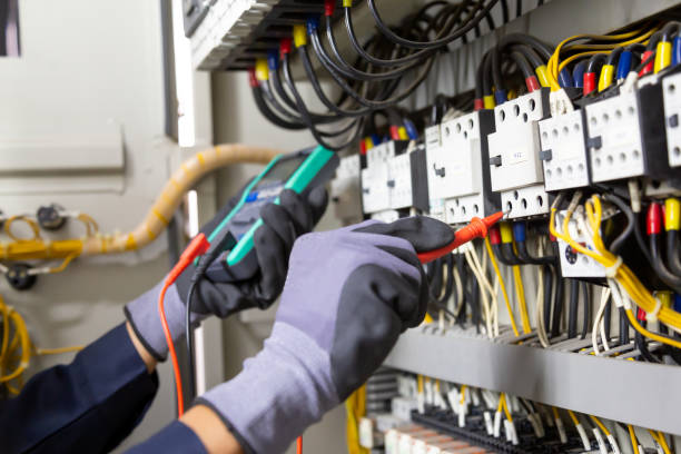 istock Electrician engineer tests electrical installations and wires on relay protection system. Adjustment of scheme of automation and control of electrical equipment. 1315756135