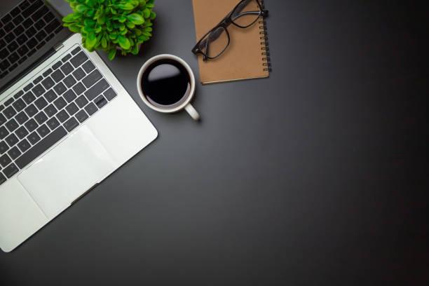 istock Workspace - Flat top view illustration of a workspace with a coffee cup and notebook on the black desk surface,Office desk concept. 1315756149