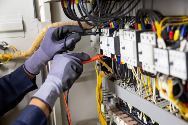 istock Electrician engineer tests electrical installations and wires on relay protection system. Adjustment of scheme of automation and control of electrical equipment. 1315756156