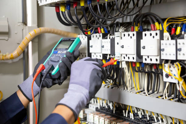 istock Electrician engineer tests electrical installations and wires on relay protection system. Adjustment of scheme of automation and control of electrical equipment. 1315756184