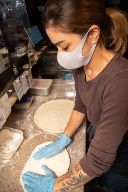 istock Young woman preparing pizza dough 1315762746