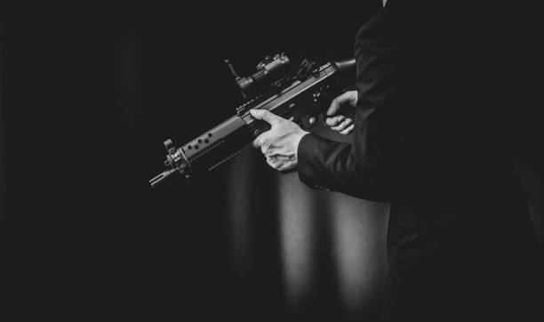 istock Man in a suits and holding assault rifle 1315773643