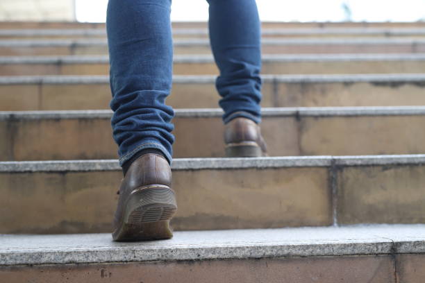 istock A young man climbing up along large endless stair alone 1315773826