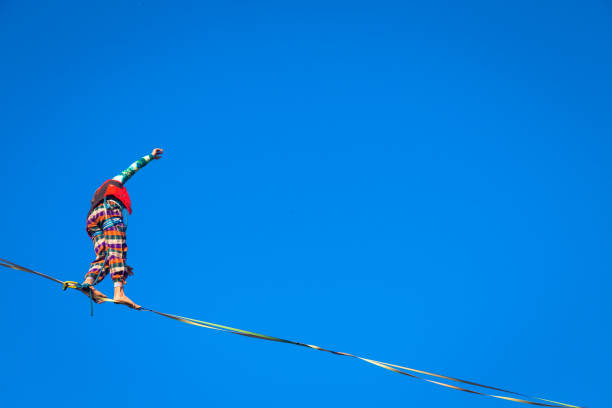 LANZO, ITALY - CIRCA OCTOBER 2020: Slackline athlete during his performance. Concentration, balance and adventure in this dynamic sport.