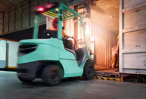 istock Motion Blur of Forklift Driver Loading Package Boxes into Shipping Container. Trailer Truck Parked Loading at Dock Warehouse. Shipment Delivery Service. Freight Truck. Shipping Warehouse Logistics. 1315783475