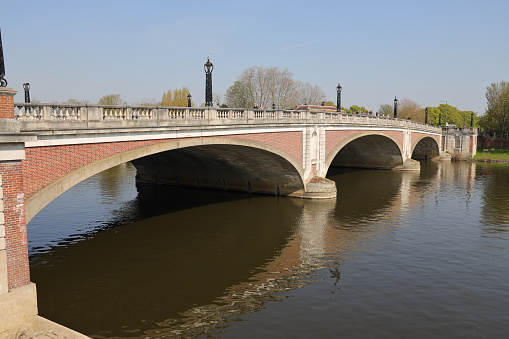 Hampton Court Bridge is a Grade II listed bridge that crosses the River Thames in England approximately north–south between Hampton, London and East Molesey, Surrey, carrying the A309.
