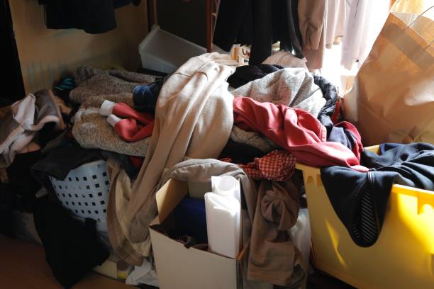 Room with piles of clothes