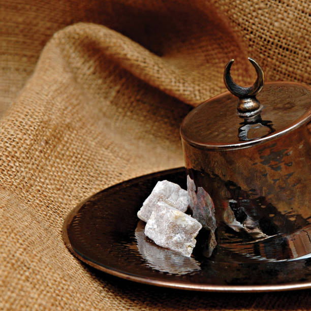 istock Turkish delight with double roasted pistachio nuts in traditional fez shaped copper cup. Turkish sweets in copper handicraft holloware serving pots. Easter flavors Turkish dessert and flavors, Turkish cuisine in traditional serving style. 1315789302